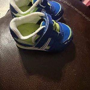 Circle baby shoes blue & lime green little rubbing on one shoe